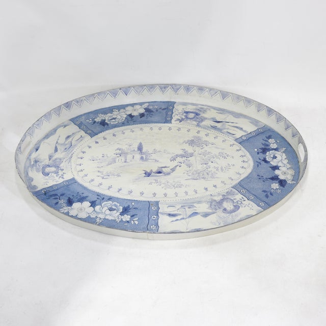 This stunning vintage oval tole tray features a classic blue and white aesthetic with an intricate hand-painted...