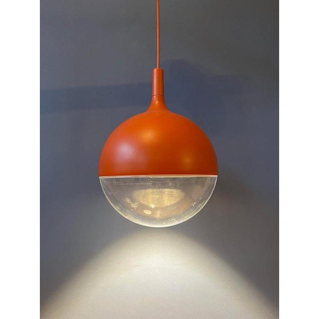 stunning IKEA Väster pendant light in a vibrant orange finish, featuring a playful, aquarium-inspired design that creates...