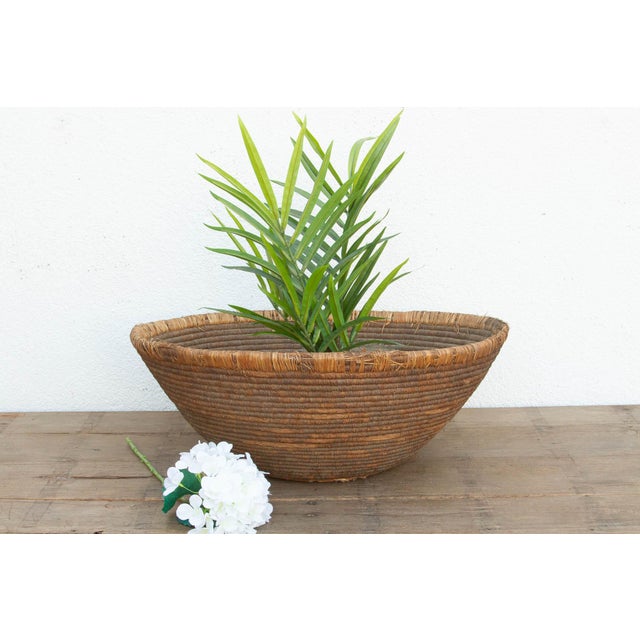 This massive, nomadic harvest bowl is a stunning piece of utilitarian history. Long before modern storage, oversized,...