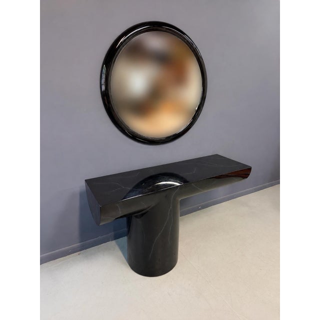 A monumental and highly sculptural postmodern console table with matching round mirror by acclaimed American designer J....