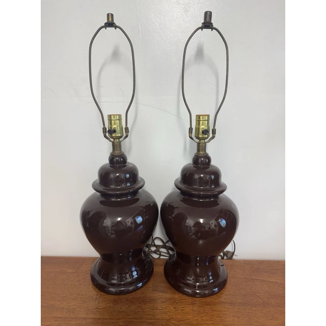 Elegant matching pair of vintage brown ceramic ginger jar table lamps in a Hollywood Regency/Mid-Century Modern style....