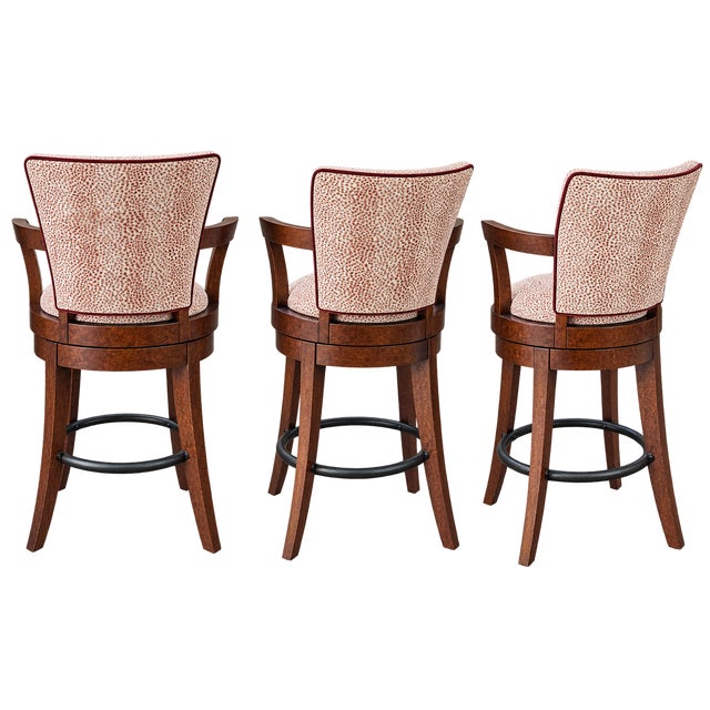 Elevate your kitchen or bar area with this sophisticated set of four transitional swivel bar stools by Swaim. These pieces...