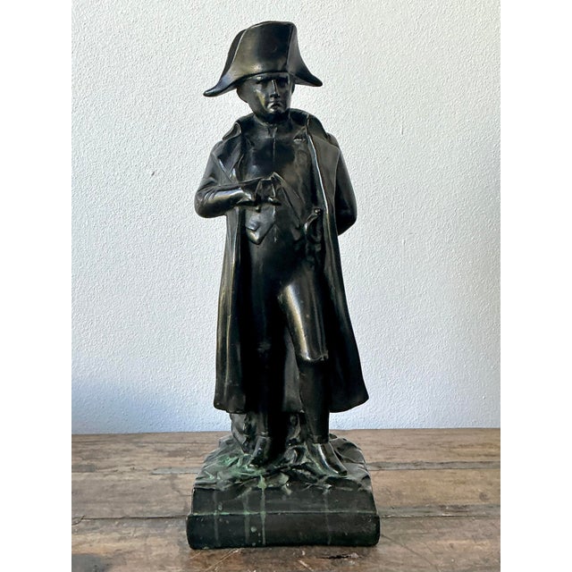 This commanding vintage bronze statue captures Napoleon Bonaparte in his most iconic silhouette, donning his legendary...