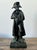 This commanding vintage bronze statue captures Napoleon Bonaparte in his most iconic silhouette, donning his legendary...