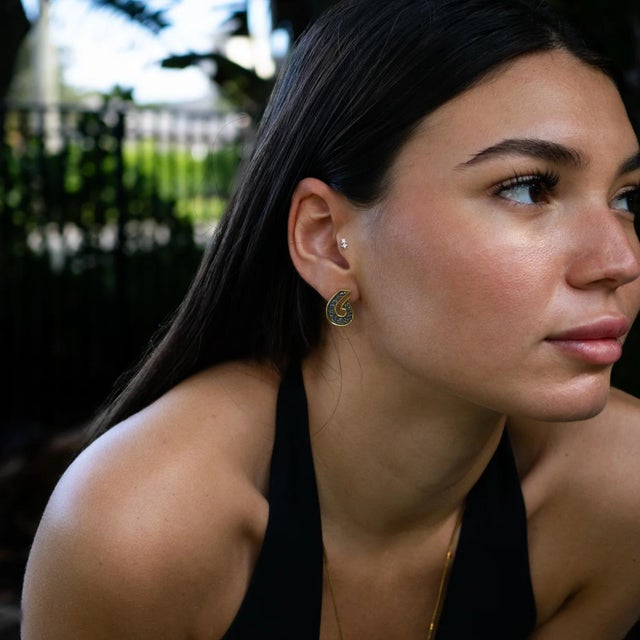 Step into the mystery of ancient symbols with the Sacred Script Two Tone Stud Earrings. Handcrafted in sterling silver and...