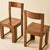 This set of six Italian dining chairs from the 1970s feature a warm walnut-toned wood with a rich, medium-brown finish....