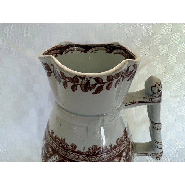 An Ironstone pitcher made by Cork, Edge, Malkin & Co.in a transfer ware pattern with geometric borders. It is the Thistle...