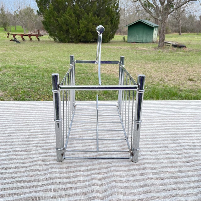 Mid century modern chrome magazine rack with faux bamboo detailing. This piece is in great shape. Sturdy, and can hold a...