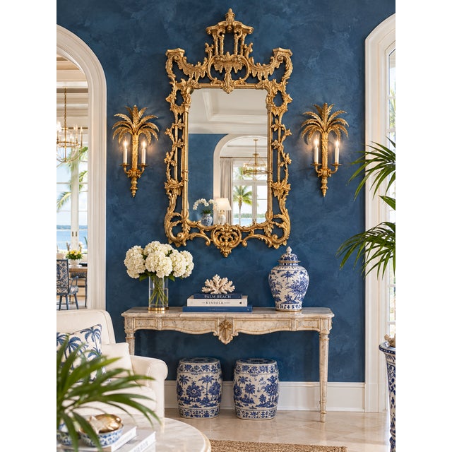 An exceptional circa 1920–1940 Chinoiserie mirror, entirely hand-carved in wood, featuring an elaborate and deeply...