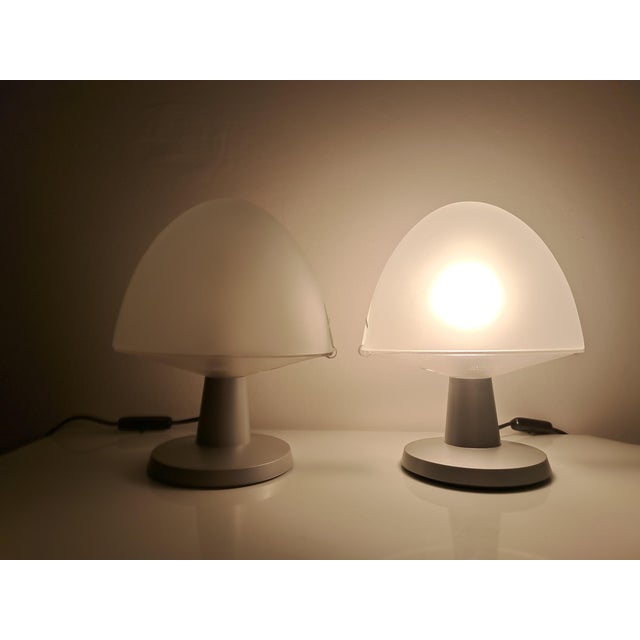 Pair of diffused light lamps. Transparent pressed glass diffuser with a satin finish. Transparent plastic base with a...