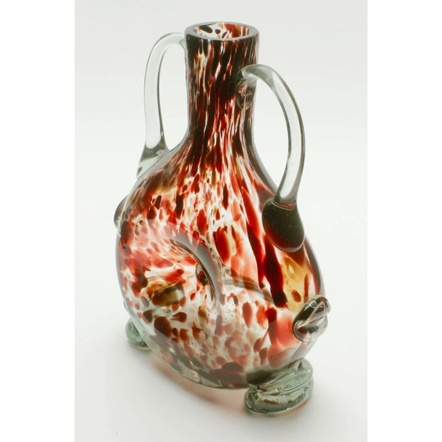 Studio glass vase based on a mouth-blown bottle shape of tortoise-shell splatter pattern (in red/brown), indented in the...