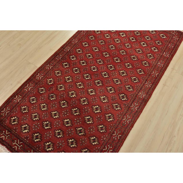 An authentic vintage tribal Baloch rug hand-knotted with fine wool and natural dyes. This nomadic rug features an all-over...