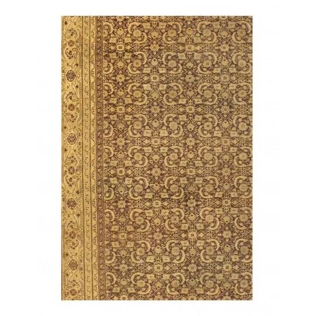 A mesmerizing and ornate mahi fish design pattern marches across the central red field of this antique Agra rug. Each...