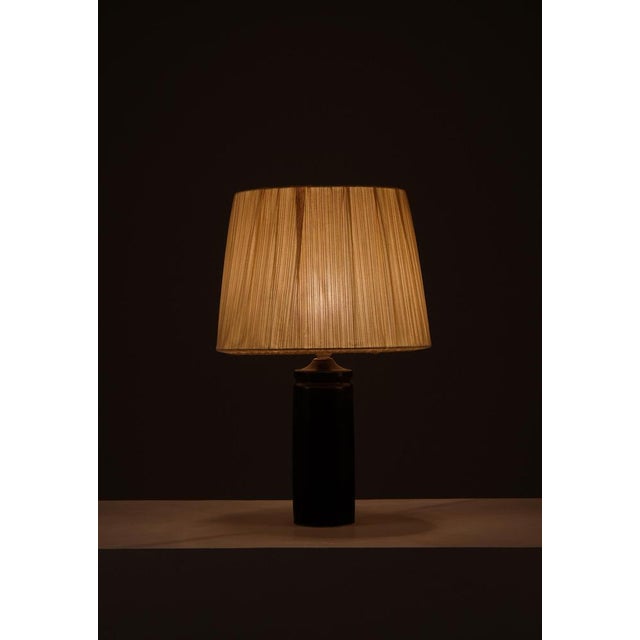 Brown glazed stoneware, table lamp designed by Carl-Harry Stålhane and produced by Rörstrand, 1950s. This piece is...