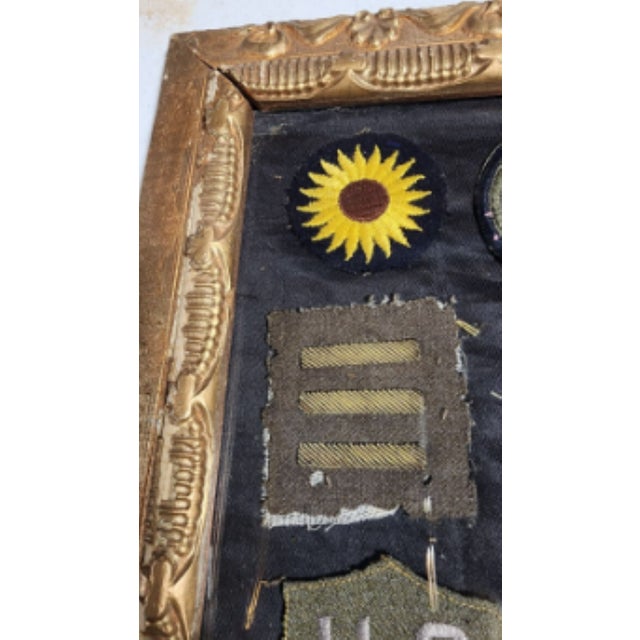 The frame, the badges, even the glass is fantastic! The badges are all sewn onto a piece of black fabric, which appears to...