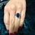 GIA certified 5.11 carat cushion cut natural blue sapphire solitaire ring in 14K yellow gold featuring no heat treatment...