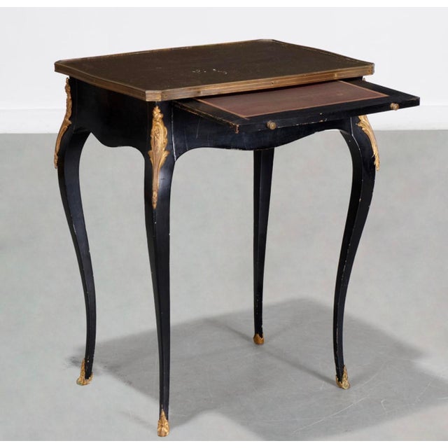 This a very elegant late 19th-century French Napoleon III period mechanical table executed in a rich ebonized finish with...