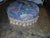 Super cute little vintage blue floral Paisley ottoman with gold Fringe. Very cushy and comfortable. Button accent in...