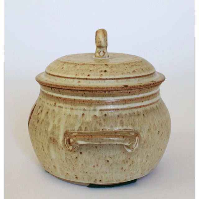 Vintage lidded pottery colander with wheat motif. No makers mark. Minor wear.