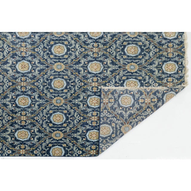 Elevate your living space with this hand-knotted wool rug, blending traditional motifs and modern Ikat-inspired geometry....