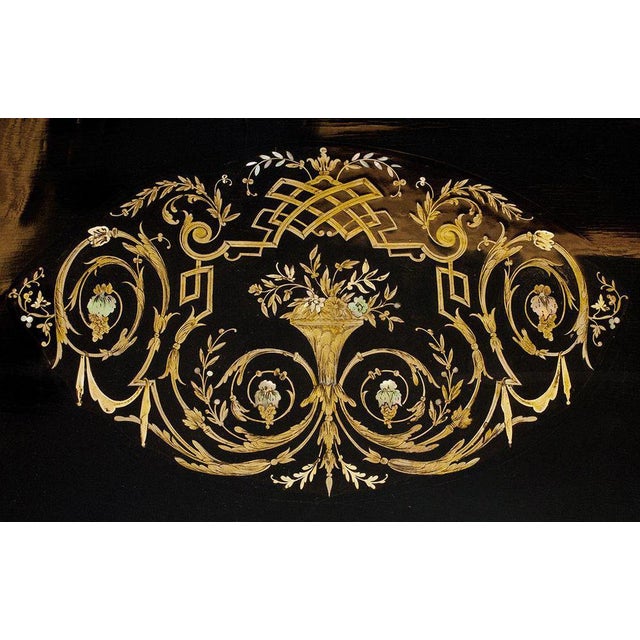 End of 19th century. Wood, black polishing, brass inlates, nacre. Size 75x128x70 cm