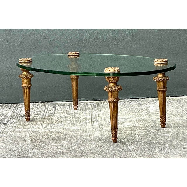 This stunning oval coffee table embodies the peak of Hollywood Regency glamour, echoing the timeless elegance associated...