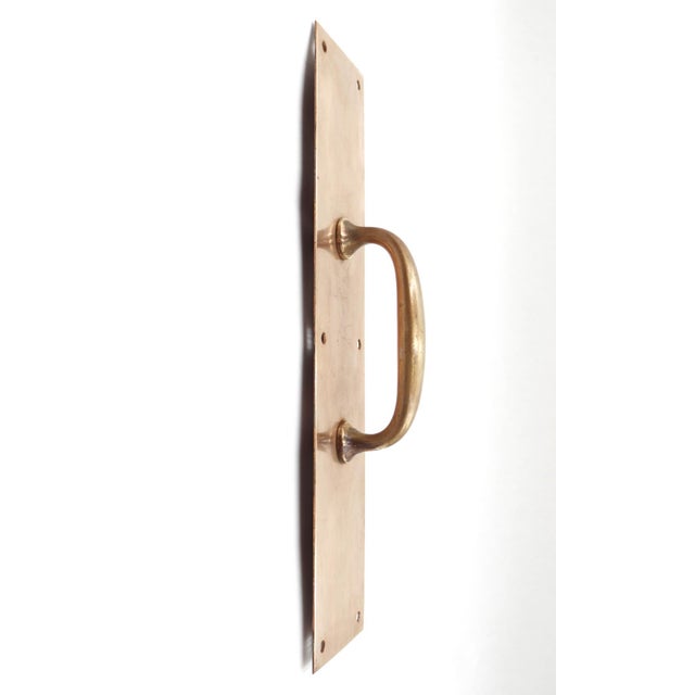 Commercial style door pulls made of brass with a polished finish. The original mounting screws are not available. Good...