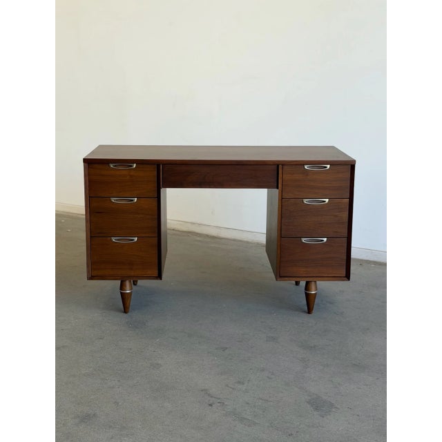 W48 D22.25 H30 KW20.5 KC23 Freshly refinished, this vintage Broyhill executive desk showcases clean mid-century lines,...