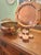 A timeworn set of vintage copper measuring cups, rich with patina and old-world charm. Crafted with solid copper bodies...