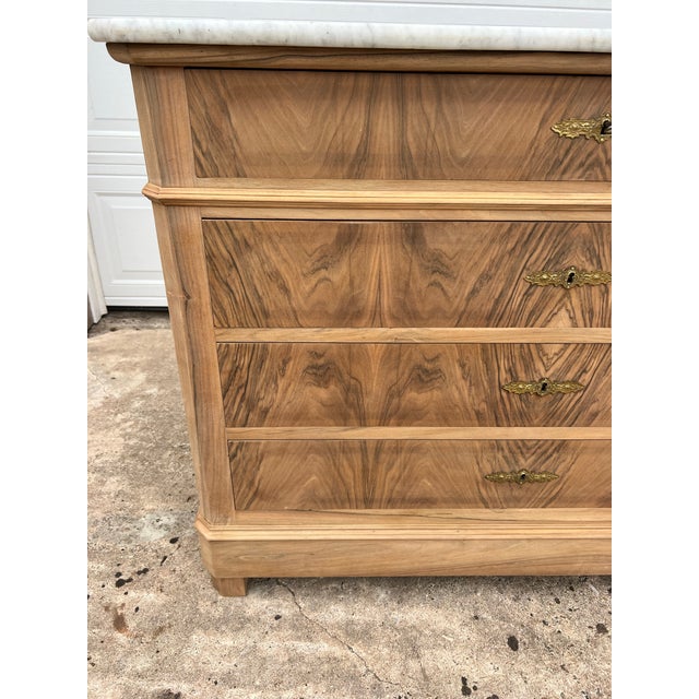 Beautiful French 19th-century Louis Philippe commode crafted in richly figured walnut, featuring dramatic bookmatched...
