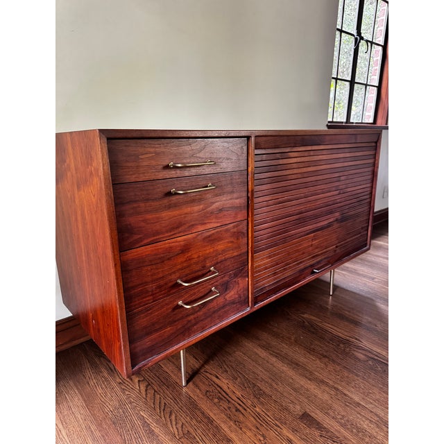 A beautiful walnut credenza buffet designed by Jens Risom, circa 1960. It features the highest quality in materials and...