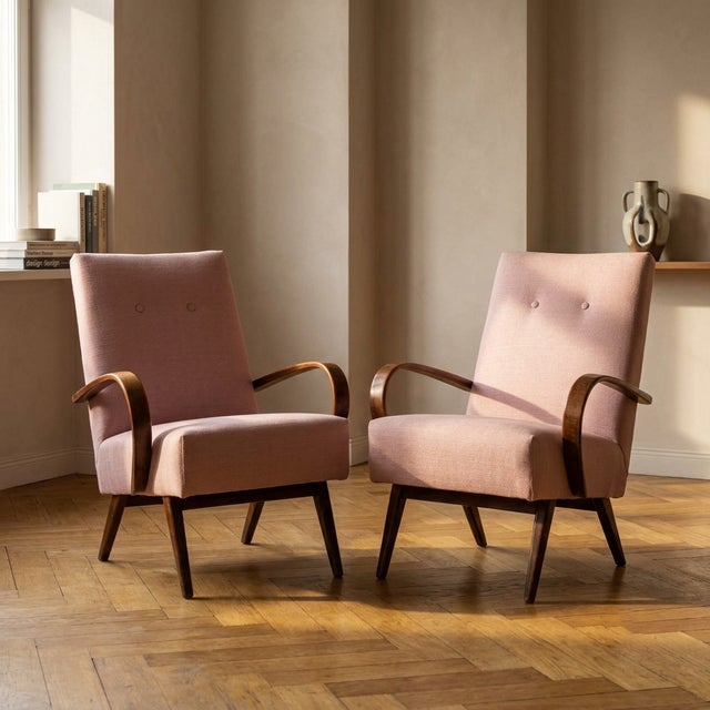 A pair of bentwood lounge armchairs designed by Jaroslav Šmídek, produced in Czechoslovakia. The chairs feature sculptural...