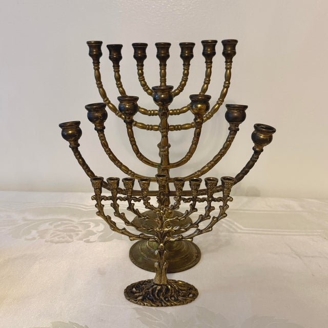 A striking collection of three vintage solid brass menorahs, believed to date from the 1960s–1970s. The grouping brings...