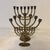 A striking collection of three vintage solid brass menorahs, believed to date from the 1960s–1970s. The grouping brings...
