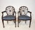 A nice vintage pair of Hepplewhite style wheelback armchairs with oval-shaped backrests and spiderweb detailing, shaped...