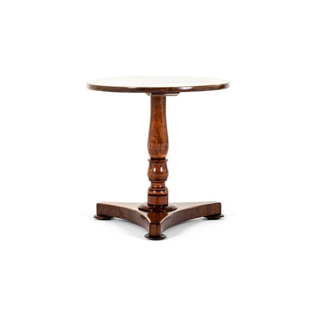 A good early victorian wine table or occasional table in mahogany. Circular top raised on a slender turned graduating...