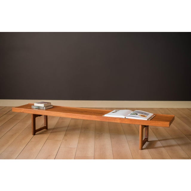 Mid Century Modern low coffee table bench designed by Torbjørn Afdal for Bruksbo, Norway. Features rich teak grains and...
