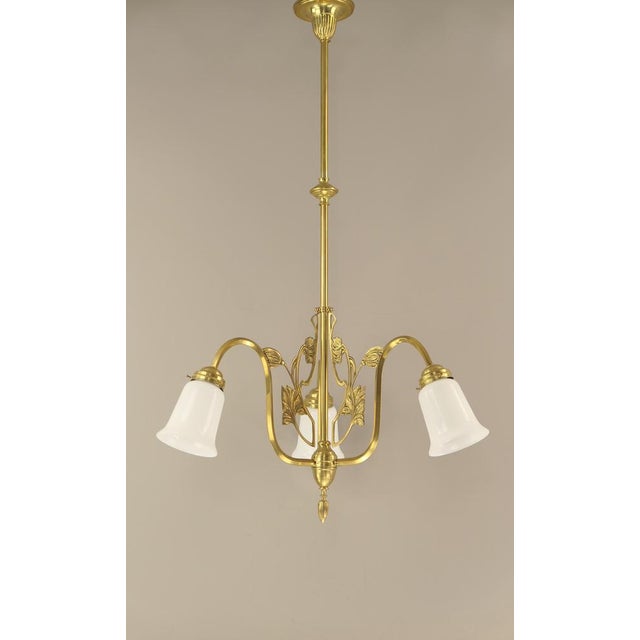 Chandelier made of massive brass with opal glass shade. The light provides a pleasant, glare-free light. Polished surface....