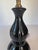 A vintage ceramic table lamp with a glossy black glaze and subtle gold spatter decoration. The elongated double-gourd form...