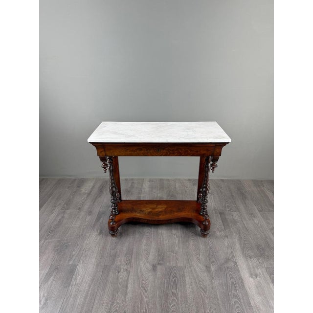 An elegant french console table in the napoleon iii style, dating from the second half of the 19th century, crafted from...