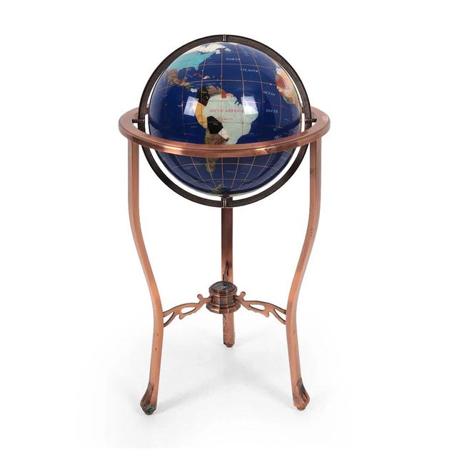 A fabulously beautiful and informative inlaid semi-precious stone globe on a copper tone stand. The globe comes complete...