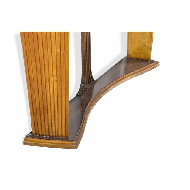 Vintage consolle with mirror is an original design item realized by Osvaldo Borsani (Varedo, 1911- Milan, 1985). An...