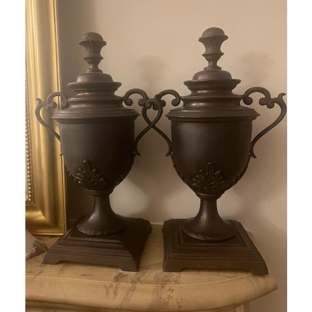 Pair of very handsome, heavy solid bronze handled urns with removable lids. Height overall is 16” including lids, width at...