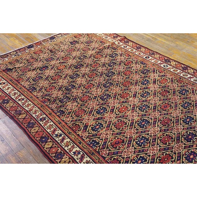 This antique allover tribal geometric earth tone Northwest Persian area rug is a striking example of the historically...