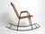 Beautiful Mid Century Modern rocking chair with armrests made of black painted metal and rattan. Typical 1950s design....