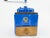 A distinctive vintage French manual coffee grinder by Peugeot Frères, featuring a vibrant cobalt-blue painted metal body...