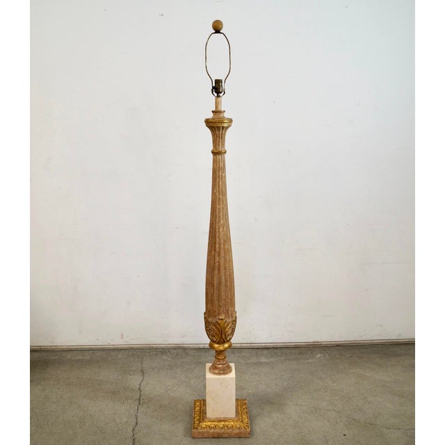 1960's Hollywood Regency Italian column floor lamp for sale. It's made of solid fluted wood, and has a solid travertine...