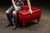 Victorian-style upholstered storage ottoman. Classic tufted ottoman featuring red leather upholstery with deep button-...