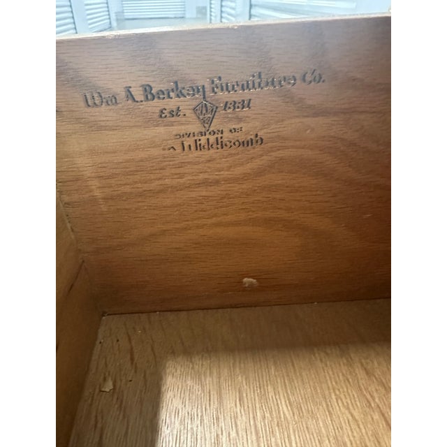 A pair of William A. Berkey for John Widdicomb Bombe Nightstands. Elevate your interior with this exquisite pair of...