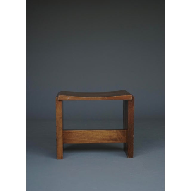 A stylish stool executed in solid walnut from the 1950s. In good used condition. Nice warm colour to the wood.
